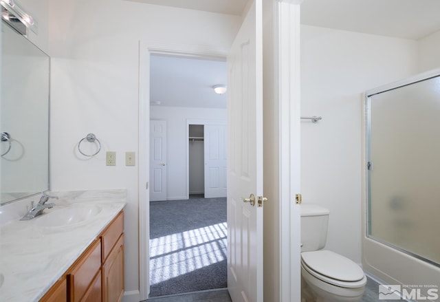 full bathroom featuring toilet, vanity, and combined bath / shower with glass door