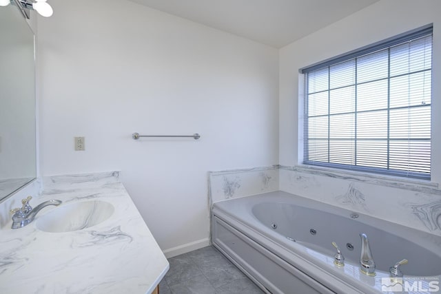 bathroom featuring vanity, tile patterned flooring, and a bath