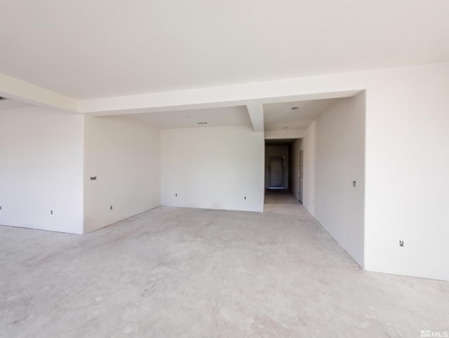 spare room with beam ceiling