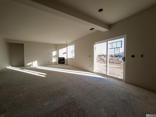 unfurnished living room featuring vaulted ceiling with beams and a fireplace