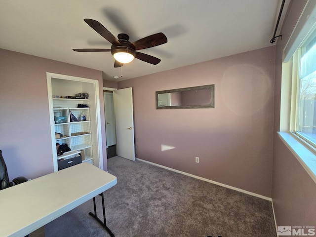 carpeted home office with ceiling fan