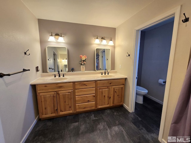 bathroom featuring hardwood / wood-style flooring, vanity, and toilet