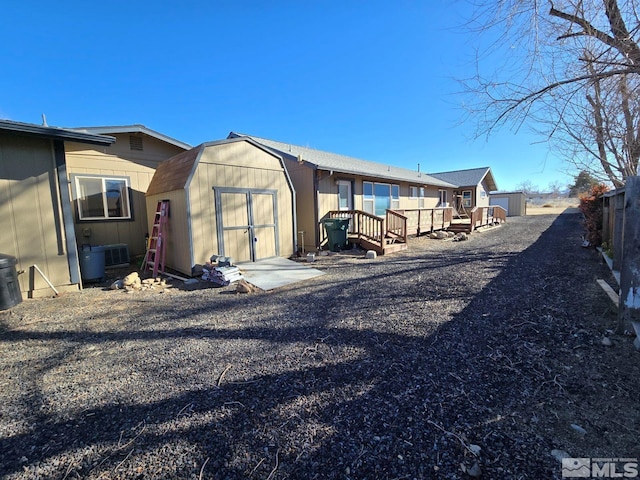 rear view of property with a shed