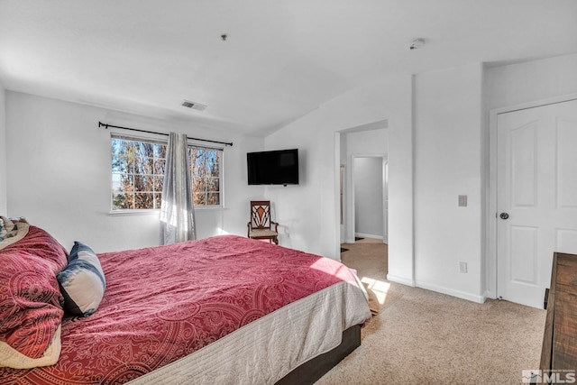 bedroom featuring vaulted ceiling and carpet