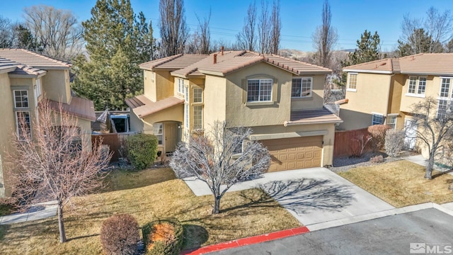 view of front of home featuring a garage and a front lawn