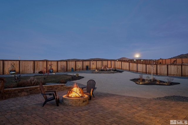 patio terrace at dusk with a fire pit