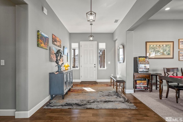 foyer with dark wood-type flooring and plenty of natural light