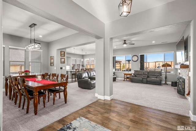 dining space featuring a fireplace and hardwood / wood-style floors