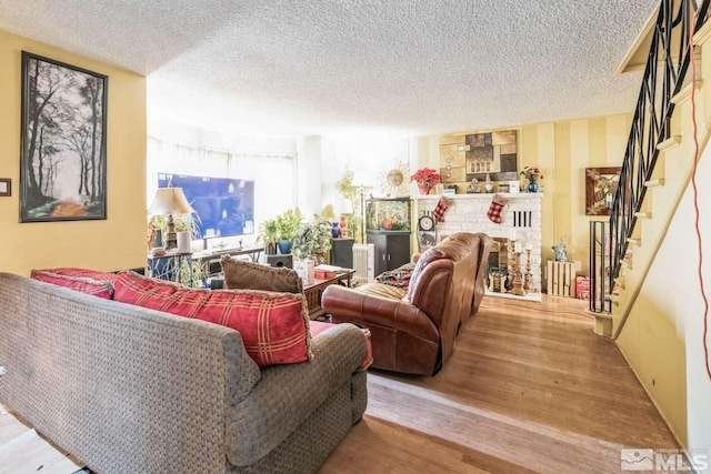 living room featuring a textured ceiling and light wood-type flooring