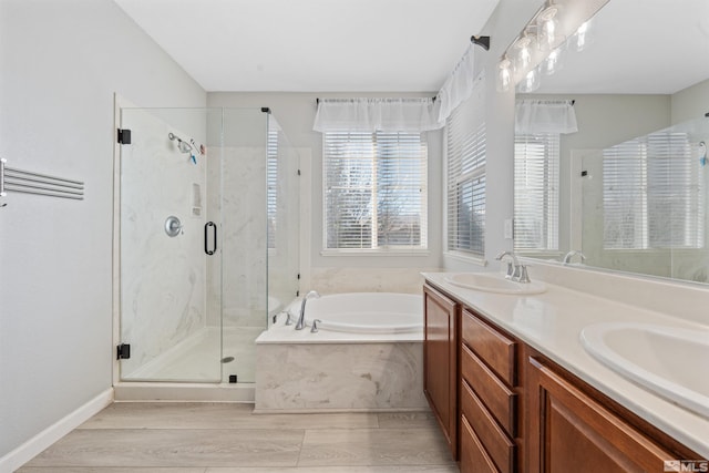 bathroom featuring shower with separate bathtub, hardwood / wood-style flooring, and vanity