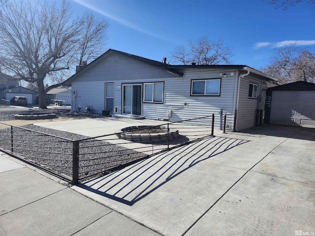 back of house featuring a garage and an outdoor structure