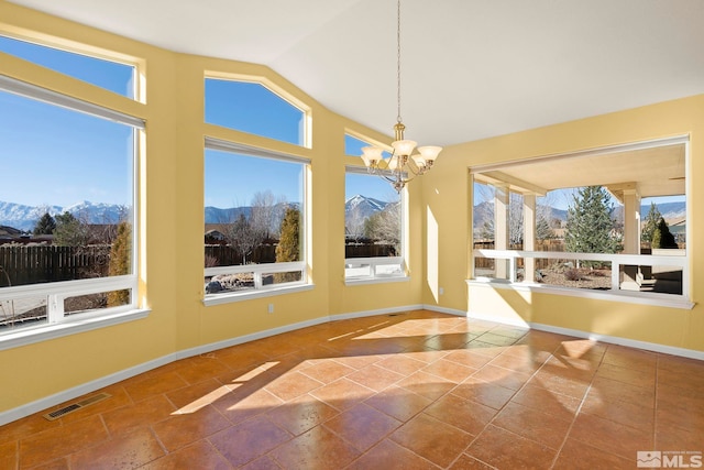 unfurnished sunroom featuring a mountain view, plenty of natural light, and vaulted ceiling