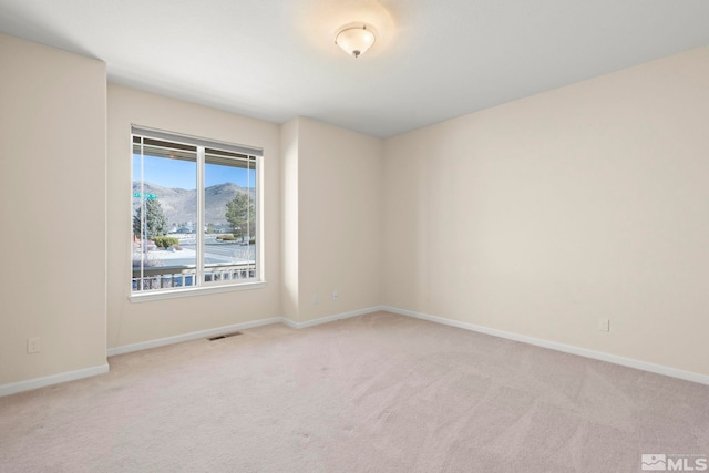 carpeted empty room with a mountain view