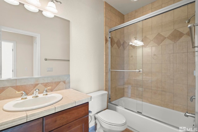 full bathroom featuring backsplash, combined bath / shower with glass door, vanity, and toilet