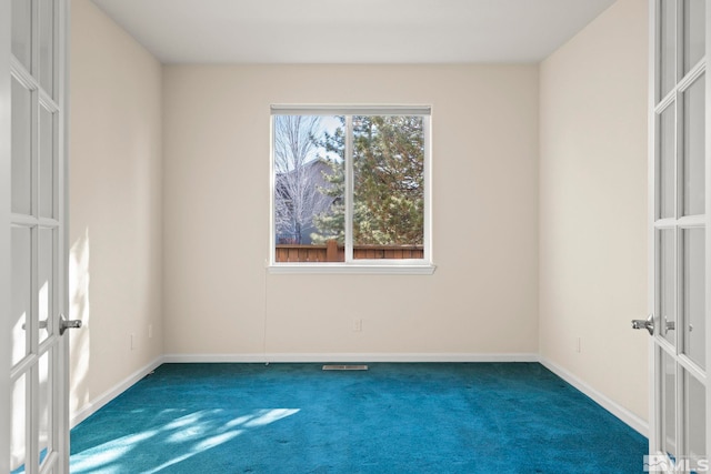 empty room featuring carpet and french doors