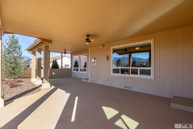 view of patio with ceiling fan and a mountain view