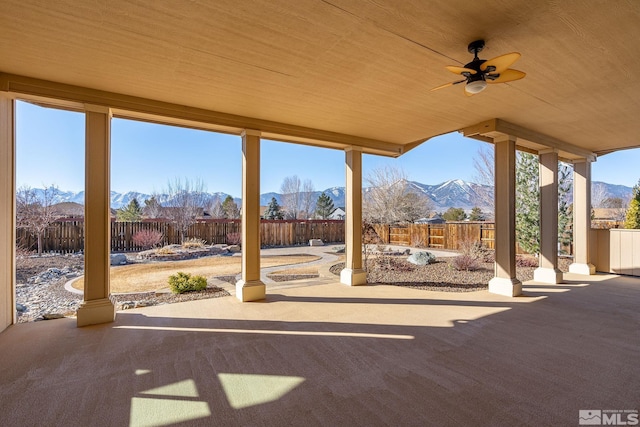 view of patio / terrace featuring ceiling fan and a mountain view