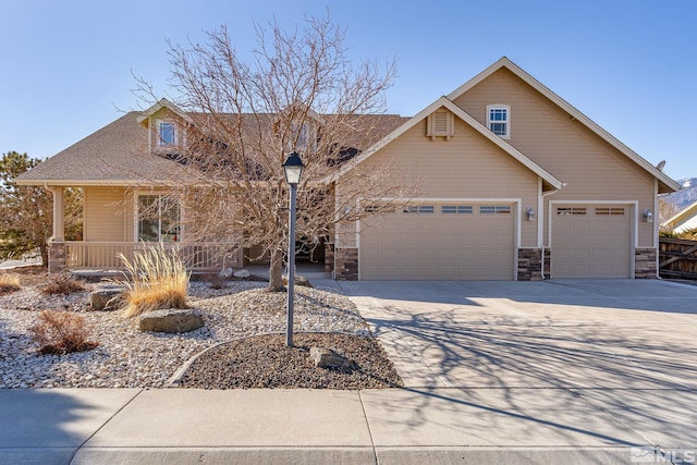 view of front of home featuring covered porch and a garage