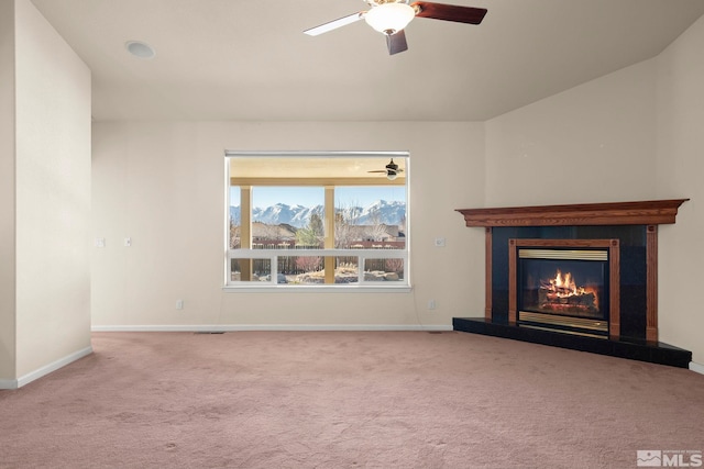 unfurnished living room featuring ceiling fan and light colored carpet