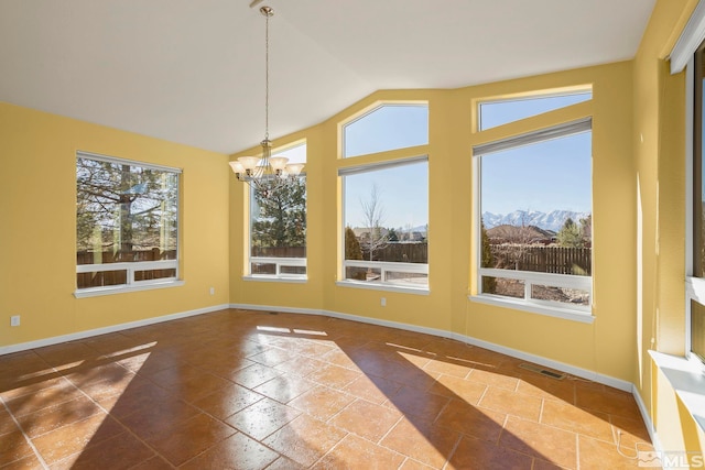 unfurnished dining area with an inviting chandelier, lofted ceiling, a mountain view, and plenty of natural light