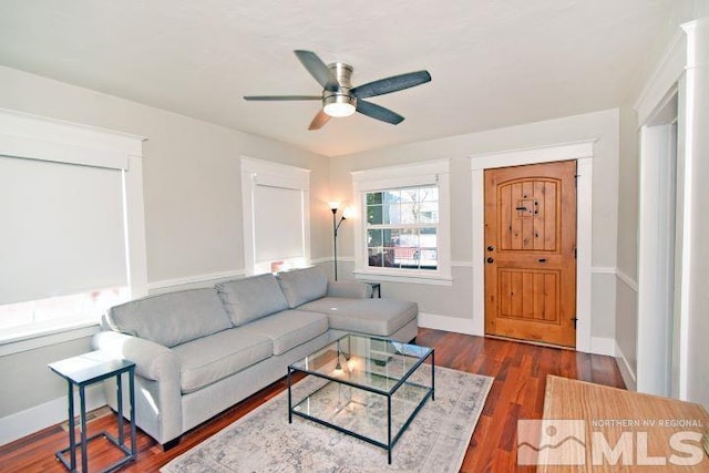 living room with ceiling fan and dark hardwood / wood-style floors