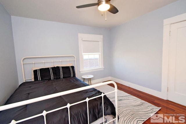 bedroom with ceiling fan and dark wood-type flooring