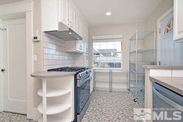 kitchen with stainless steel dishwasher, backsplash, range with gas stovetop, and white cabinetry