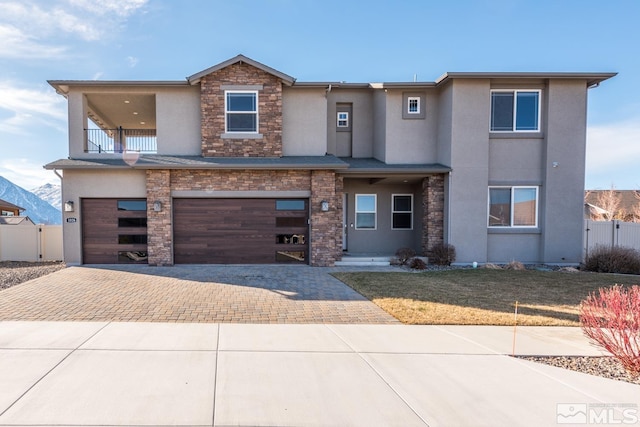 view of front of home with a garage and a balcony