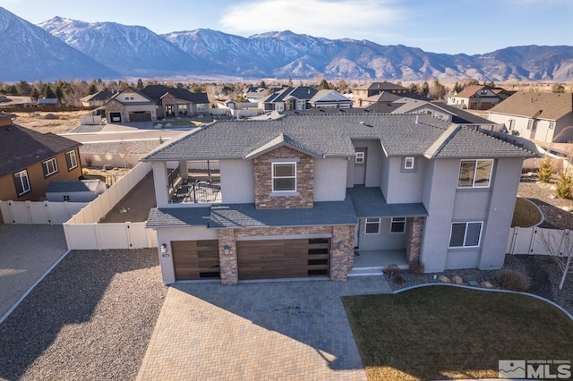 view of front facade featuring a mountain view and a garage