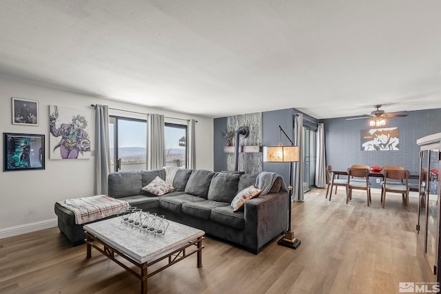 living room with hardwood / wood-style flooring and ceiling fan