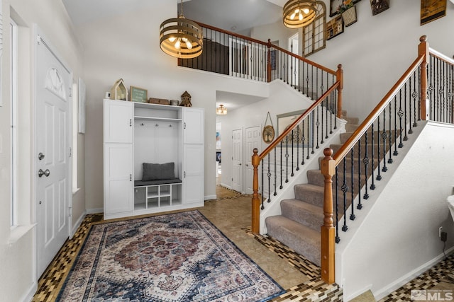 entrance foyer with a chandelier and a towering ceiling