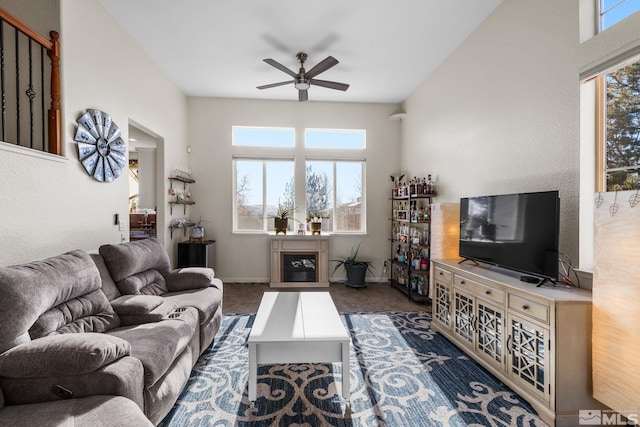 carpeted living room featuring ceiling fan and a healthy amount of sunlight