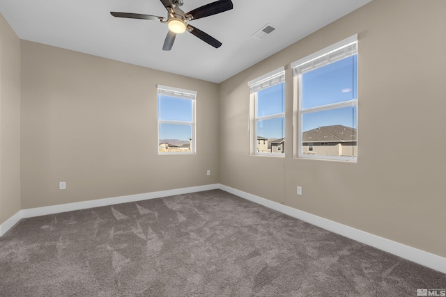 carpeted empty room featuring ceiling fan