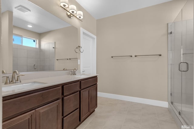 bathroom with an enclosed shower, vanity, and tile patterned flooring