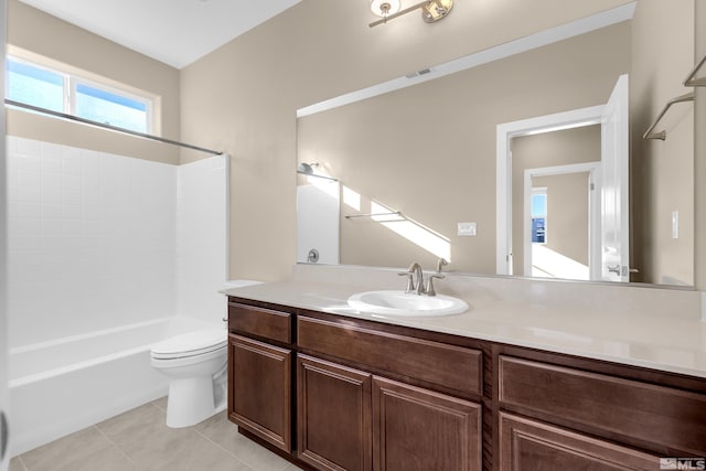 full bathroom featuring toilet, vanity, tile patterned floors, and shower / washtub combination