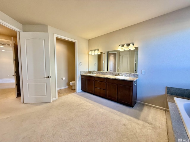 bathroom with vanity, toilet, and a bathtub