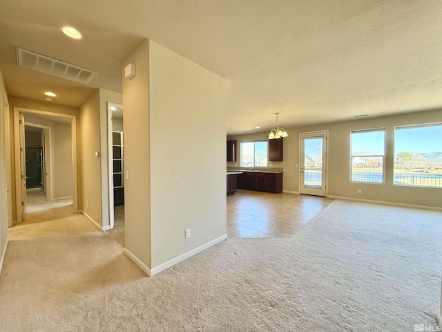 unfurnished living room with light colored carpet