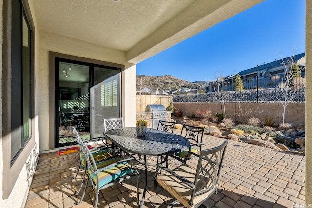 view of patio / terrace featuring a mountain view and a grill