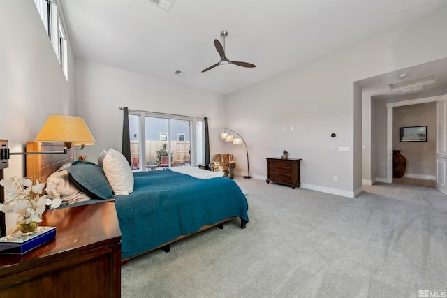 carpeted bedroom with ceiling fan and multiple windows