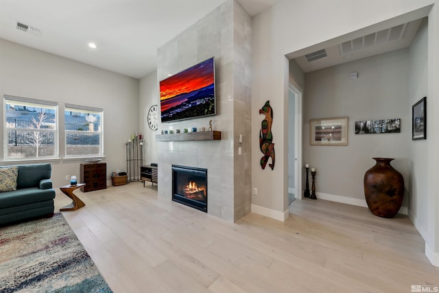 living room featuring light hardwood / wood-style floors and a fireplace