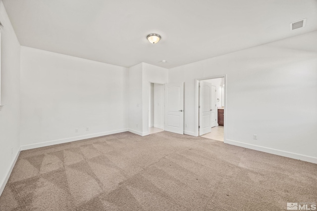 unfurnished room with light colored carpet