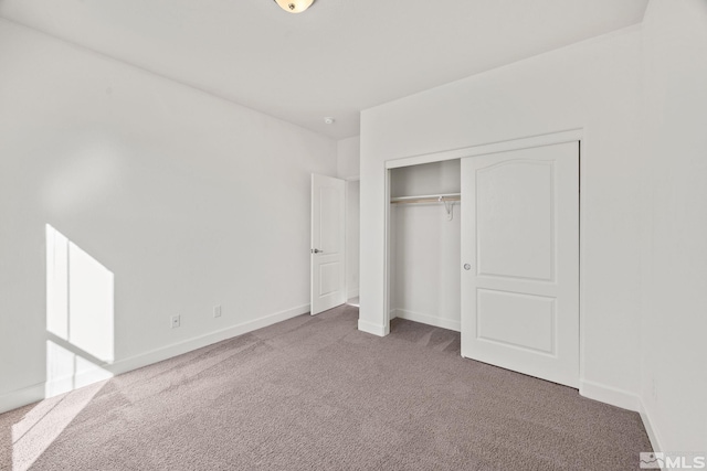 unfurnished bedroom featuring carpet floors and a closet