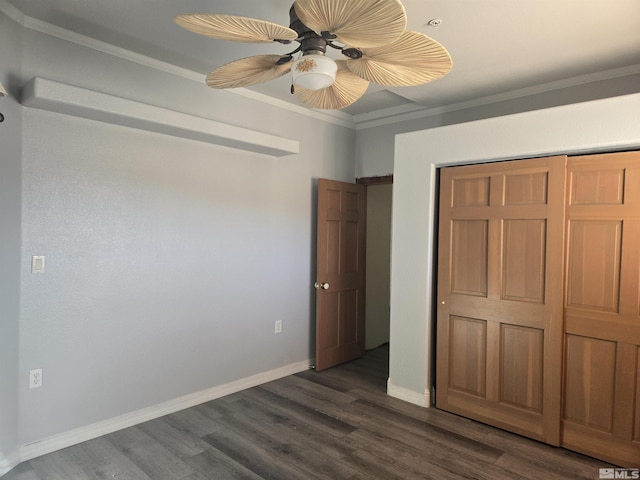 unfurnished bedroom featuring ceiling fan, dark wood-type flooring, a closet, and ornamental molding