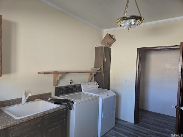 laundry room featuring crown molding, sink, dark hardwood / wood-style flooring, cabinets, and independent washer and dryer