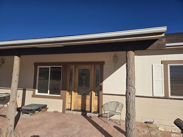 property entrance featuring a patio area