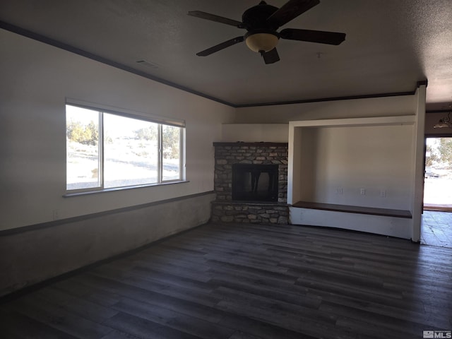 unfurnished living room with ceiling fan, dark wood-type flooring, a textured ceiling, and ornamental molding