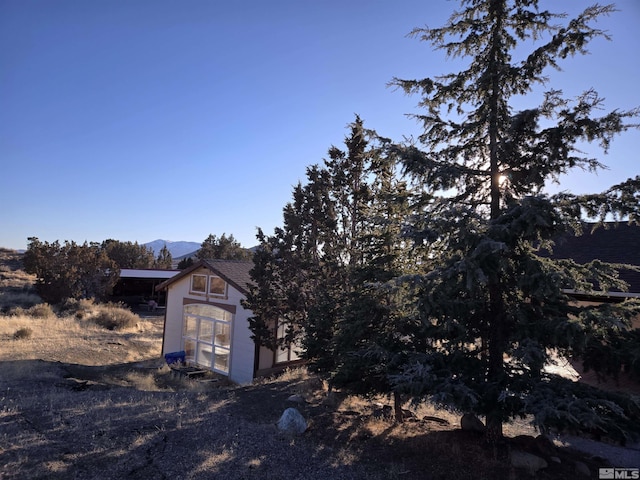 exterior space featuring a mountain view and an outbuilding