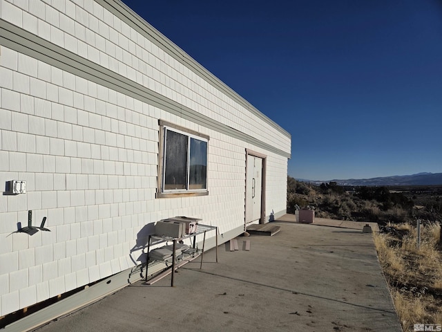 view of home's exterior featuring a patio area and a mountain view