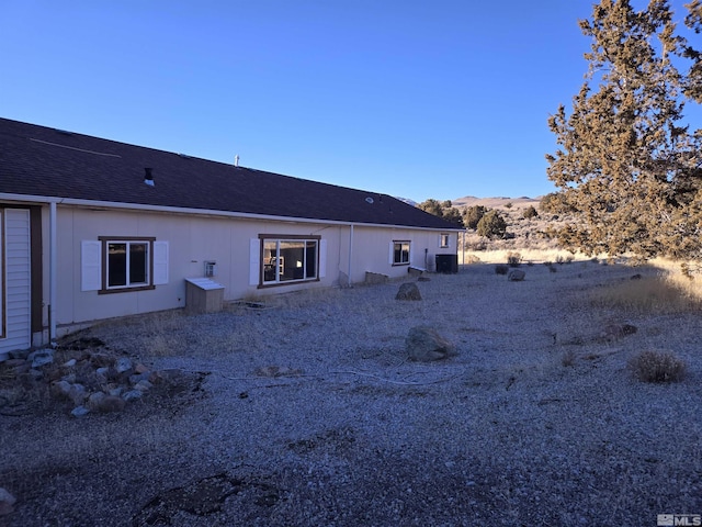 rear view of property with central air condition unit