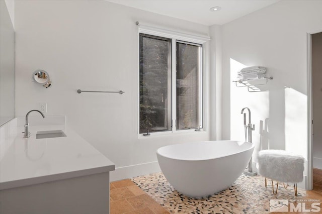 bathroom with vanity and a bathtub